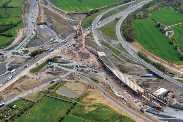 Aerial view of the site showing the M1 running from south (top right) to north (centre left) and the new interchange under construction 